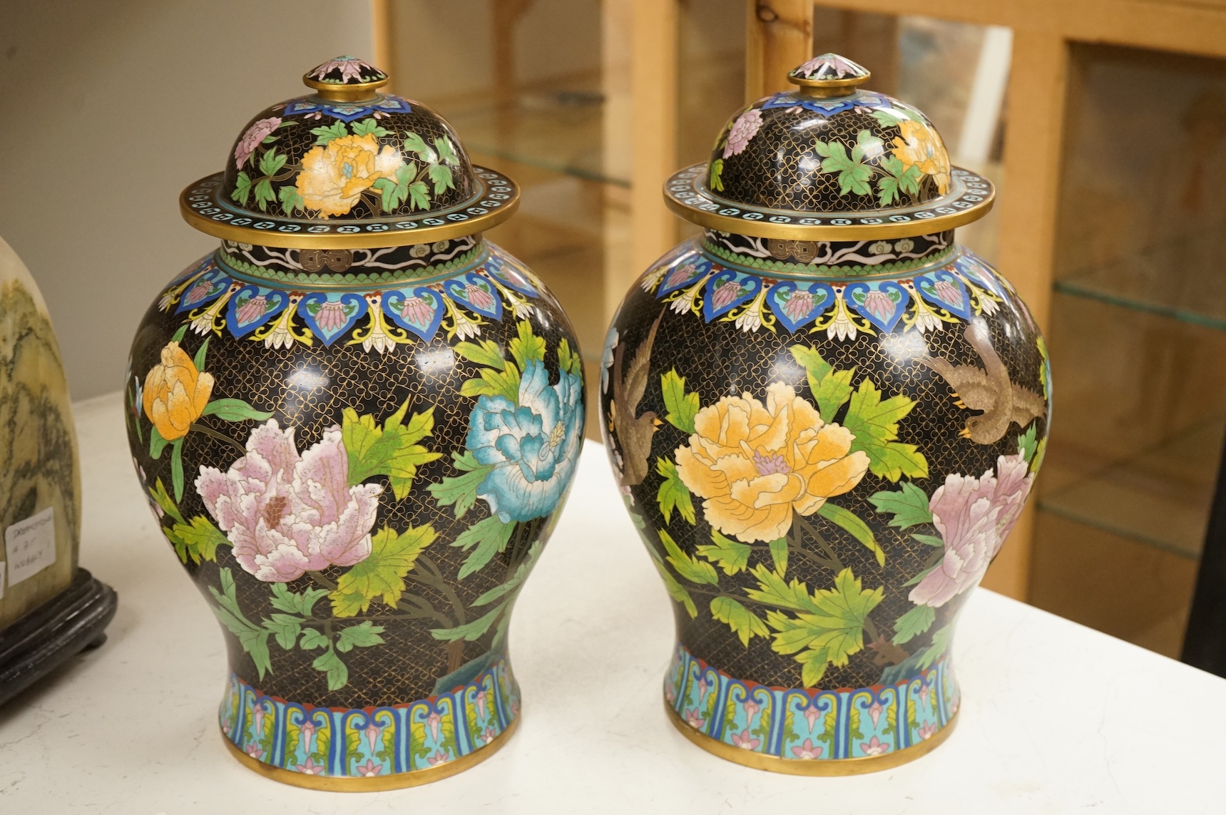 A pair of Chinese cloisonné baluster jars and covers decorated with birds and flowers, 38cm high
